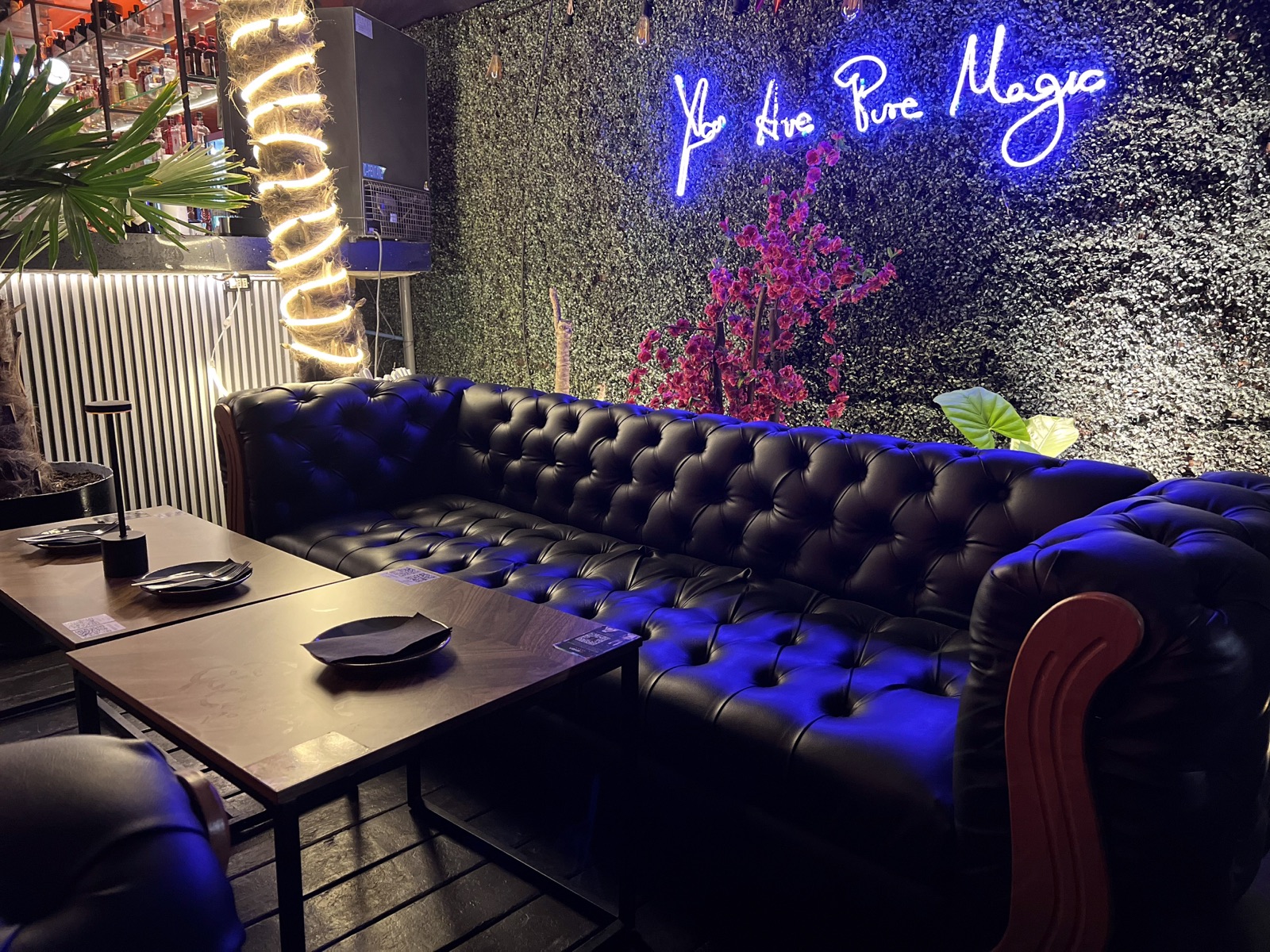 Salón de Eleven Club con sillones y luces de neón